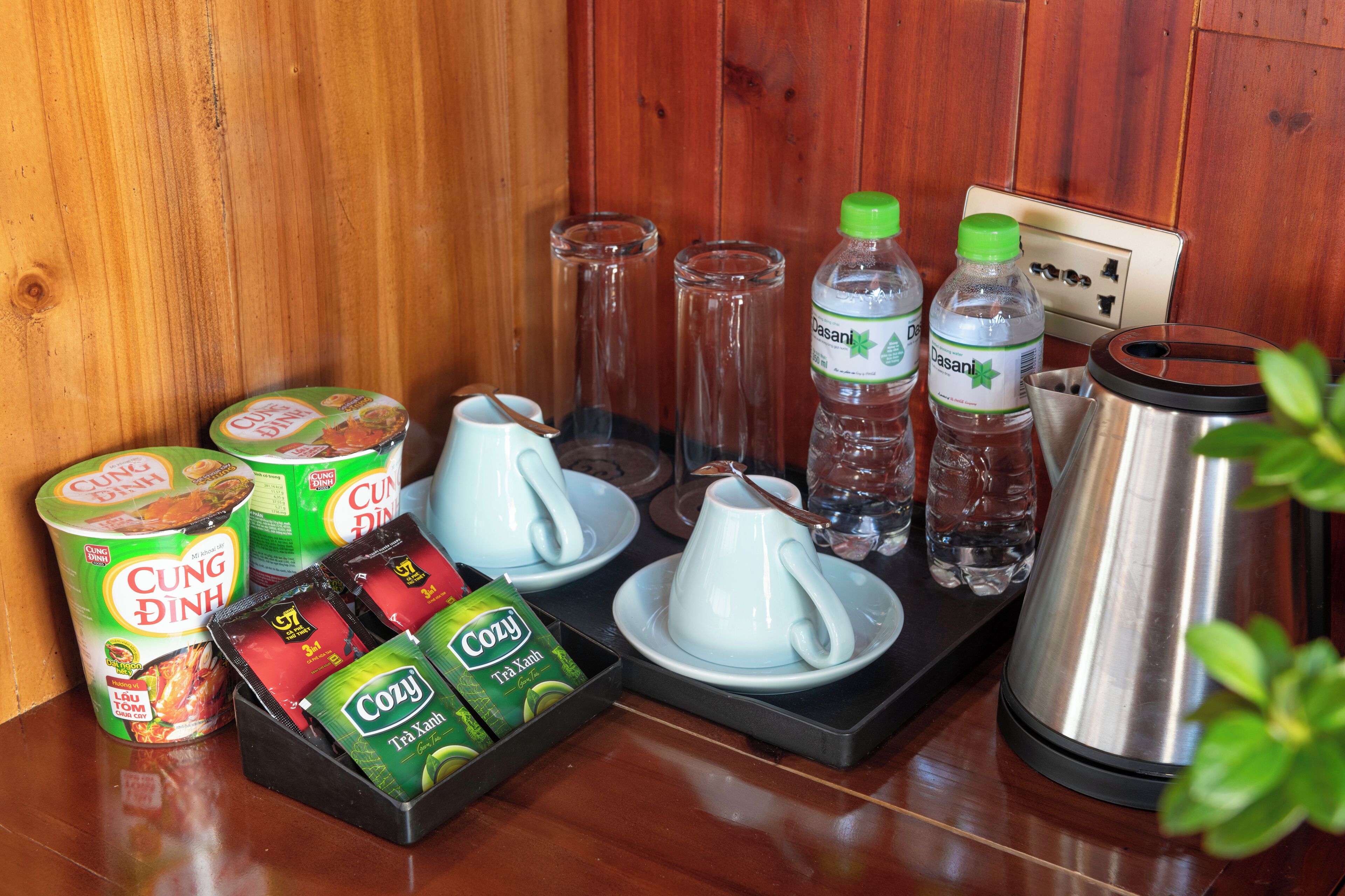 A breakfast setup with tea, coffee, and snacks.