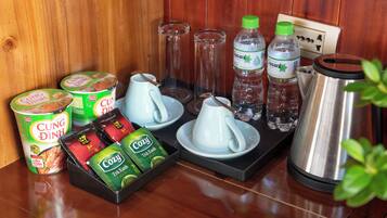 A breakfast setup with tea, coffee, and snacks.