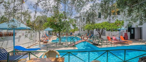 Seasonal outdoor pool, open 9:00 AM to 8:00 PM, pool umbrellas