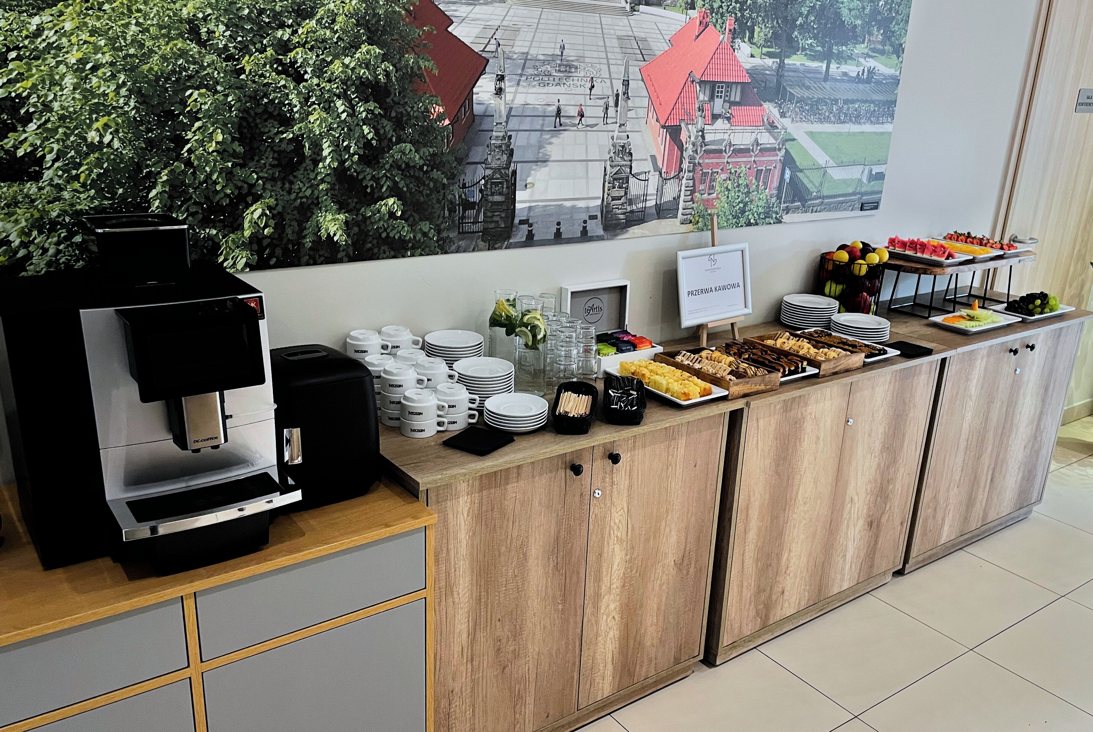 A breakfast buffet with a coffee machine, plates, cups, and a variety of food items.