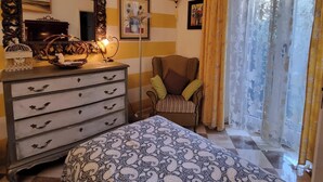 A bedroom with a bed, dresser, chair, and a large mirror. - THE HOME OF JASMINE AND MEDLAR, TO MAKE YOU FEEL AT HOME. (Firenze)