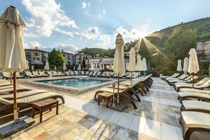 Indoor pool, seasonal outdoor pool, pool umbrellas, pool loungers