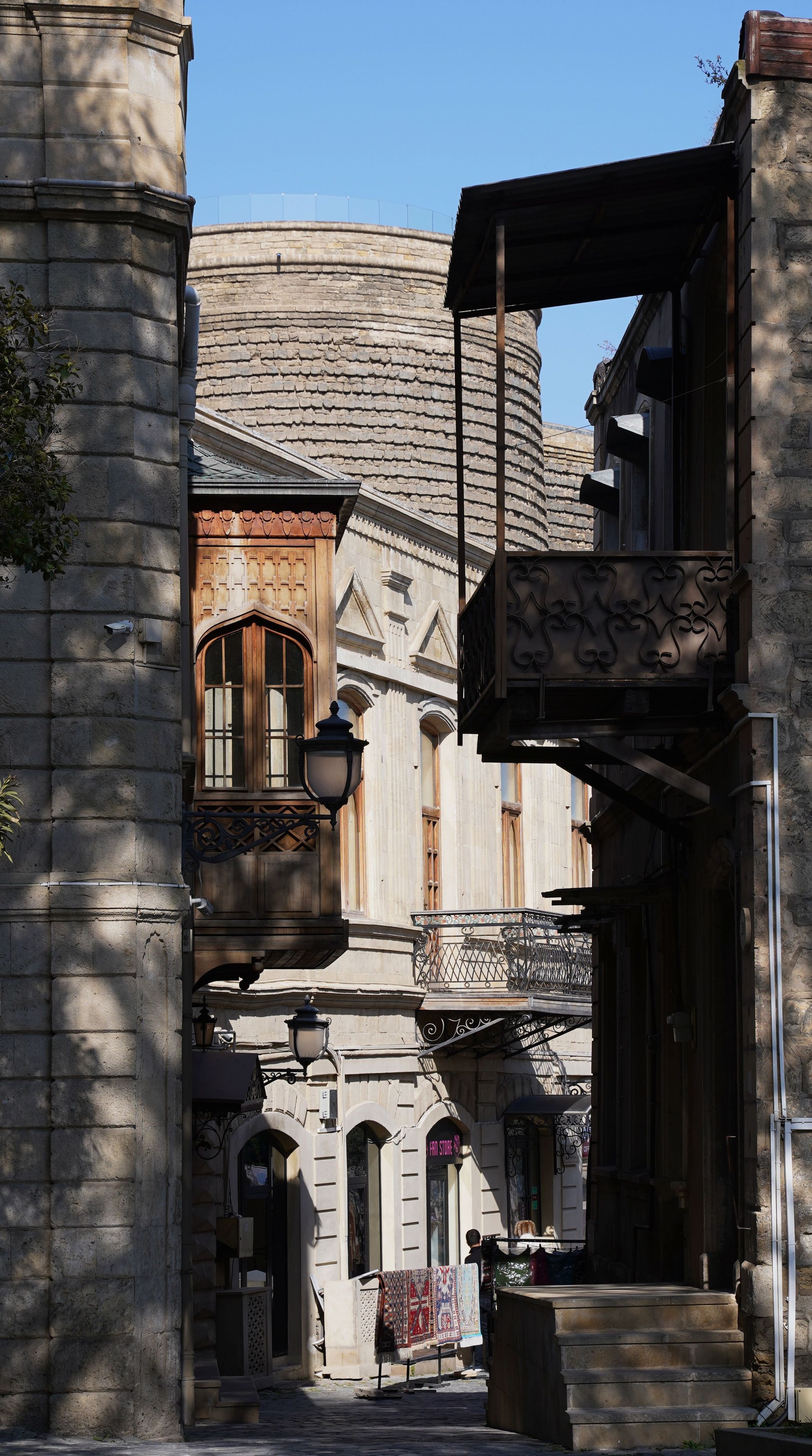 Edificio histórico con arquitectura de piedra, una puerta de madera y un letrero de tienda.