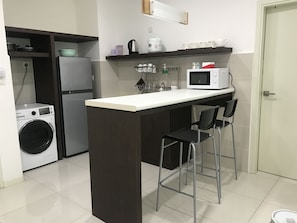 Enjoy cooking and dining in this functional kitchen with a central island, appliances, and ample workspace.