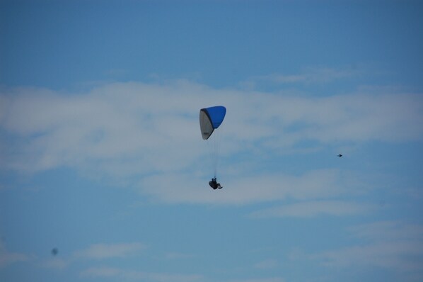 A person skydiving with a parachute against a clear sky. - APARTMENT NEAR THE BEACH (Gran Alacant)