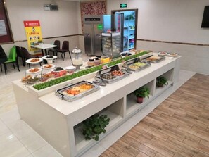 A buffet area with various food stations, a refrigerator, and seating arrangements. - GreenTree Inn Fuyang Yingshang Yingyang Rd Business Hotel (Fuyang)