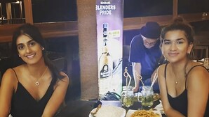 A dining table with various dishes, including rice, a bowl of yellow food, and a glass of beer. - Sizzlers Hub - Hostel (Kandy)