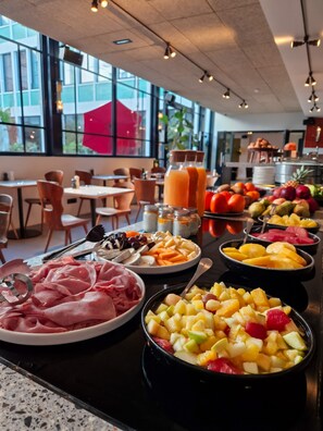 A buffet with various fruits, vegetables, and meats. - Le Grand Quartier (Paris)