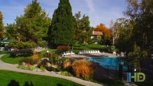 A swimming pool surrounded by a landscaped garden with a variety of trees and shrubs. There are lounge chairs arranged around the pool area. - 2 bed condo Thunderbird Resort Club - Sparks (Sparks)