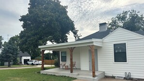 A single-story house with a covered porch, a chimney, and a small front yard. - Perfect Nest located in midtown, walk to the fairgrounds (Tulsa)