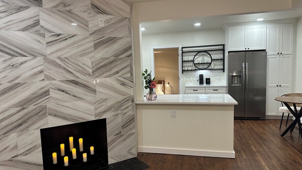 A modern kitchen with a marble backsplash, stainless steel appliances, and a central island. - Perfect Nest located in midtown, walk to the fairgrounds (Tulsa)