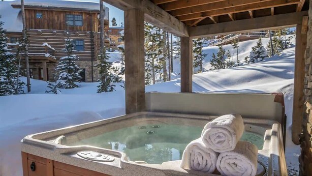 A wooden cabin with a hot tub and towels. - Luxury 5 Bedroom Big Sky Retreat (Big Sky)