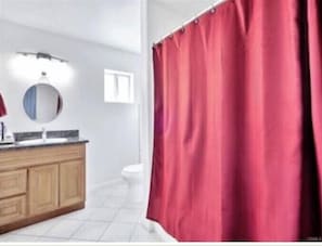 Bathtub, hair dryer, towels, soap