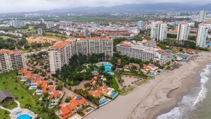 A resort with multiple buildings, a beach, and several swimming pools. - Gorgeous condo at Marina area , great views , luxury layout, jacuzzi,beach front (Puerto Vallarta)