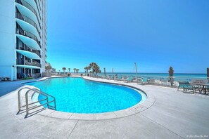 A swimming pool with a curved edge, a metal handrail, and a sign indicating shoes are required. - Upscale Perfection!  Beachfront Condo, End Unit  w/740 SqFt   Balcony!   Pool (panama city beach)