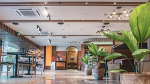 A spacious lobby with a polished marble floor, a staircase, and a reception area. - Bravo Tanauan Hotel (Tanauan City)