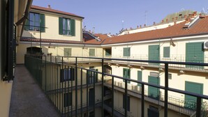 A multi-story building with balconies, railings, and a clear sky. - Italianway - Bligny 64 (Milan)