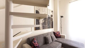 A modern living room with a grey sofa, two decorative pillows, and abstract art on the wall. - Italianway - Ripa Ticinese 17 (Milan)