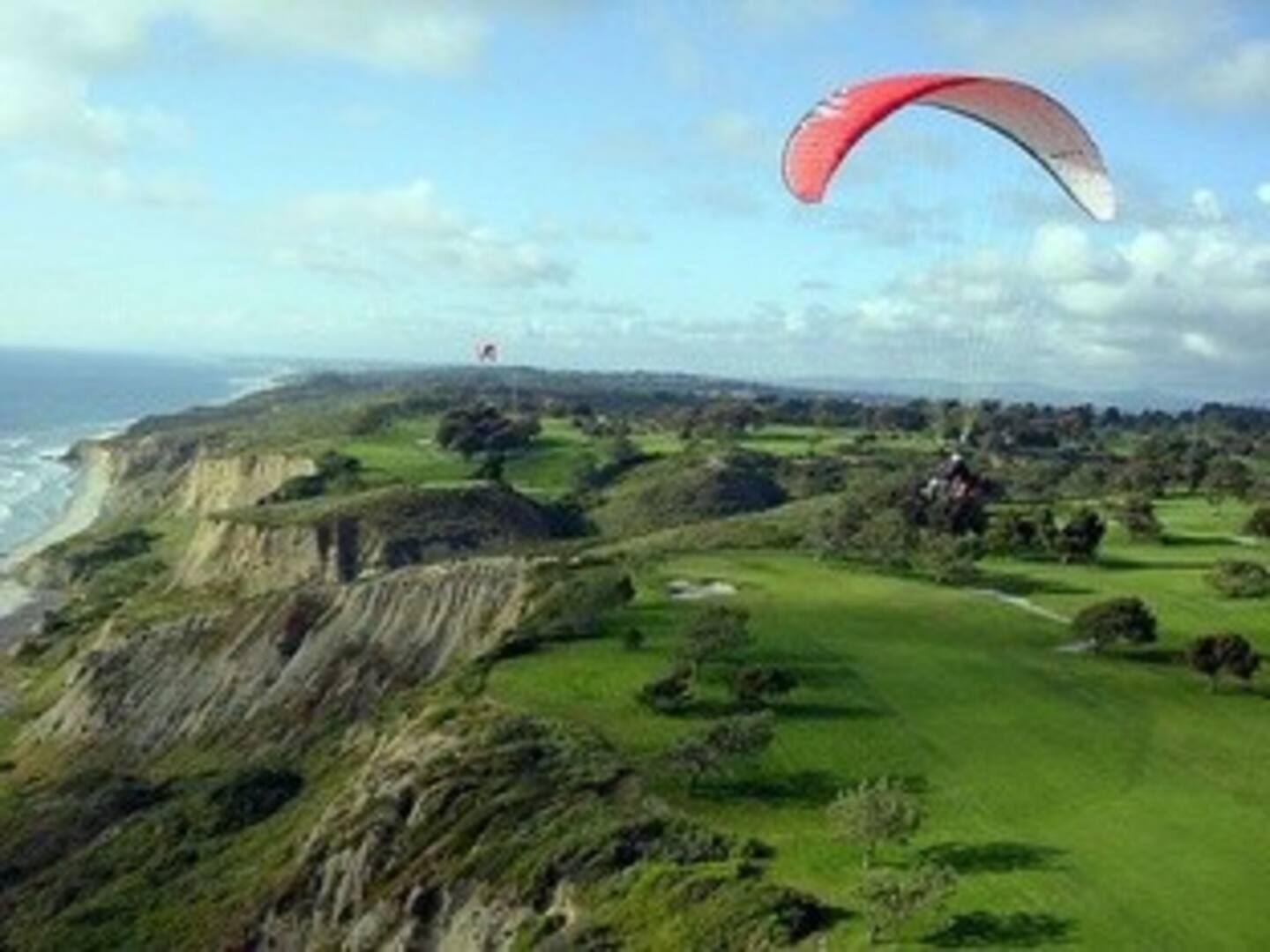 A coastal landscape with cliffs and a golf course.