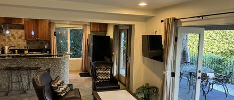 A spacious living area with a kitchen, a dining table, and a comfortable seating arrangement.