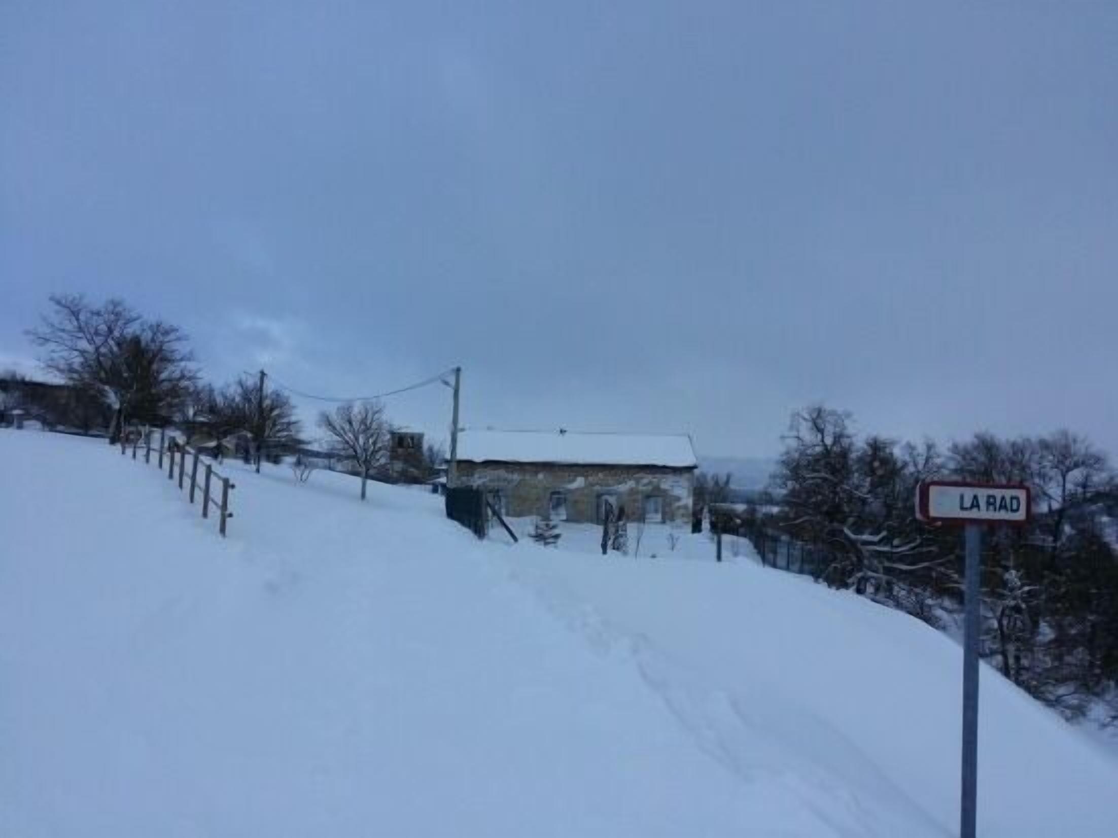 A snow-covered landscape with a sign reading "LA RAD."