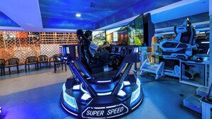 A gaming area with a racing simulator labeled "SUPER SPEED." - Kumar Resort by Turtle, Lonavala (Mawal)