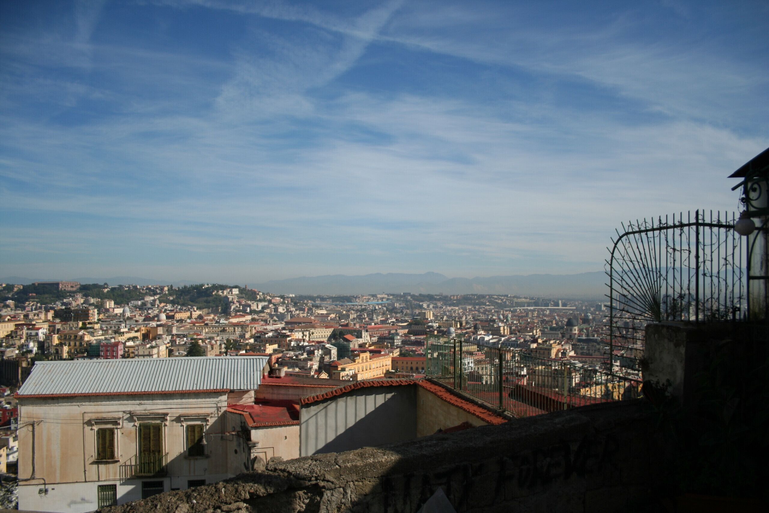 A cityscape with a view of buildings and a distant mountain range.