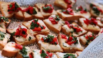 A tray of bruschetta with toppings.