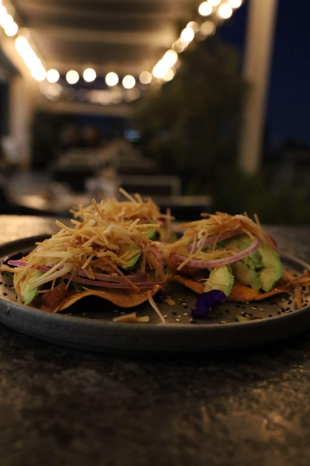 A plate of food with shredded cheese and vegetables.