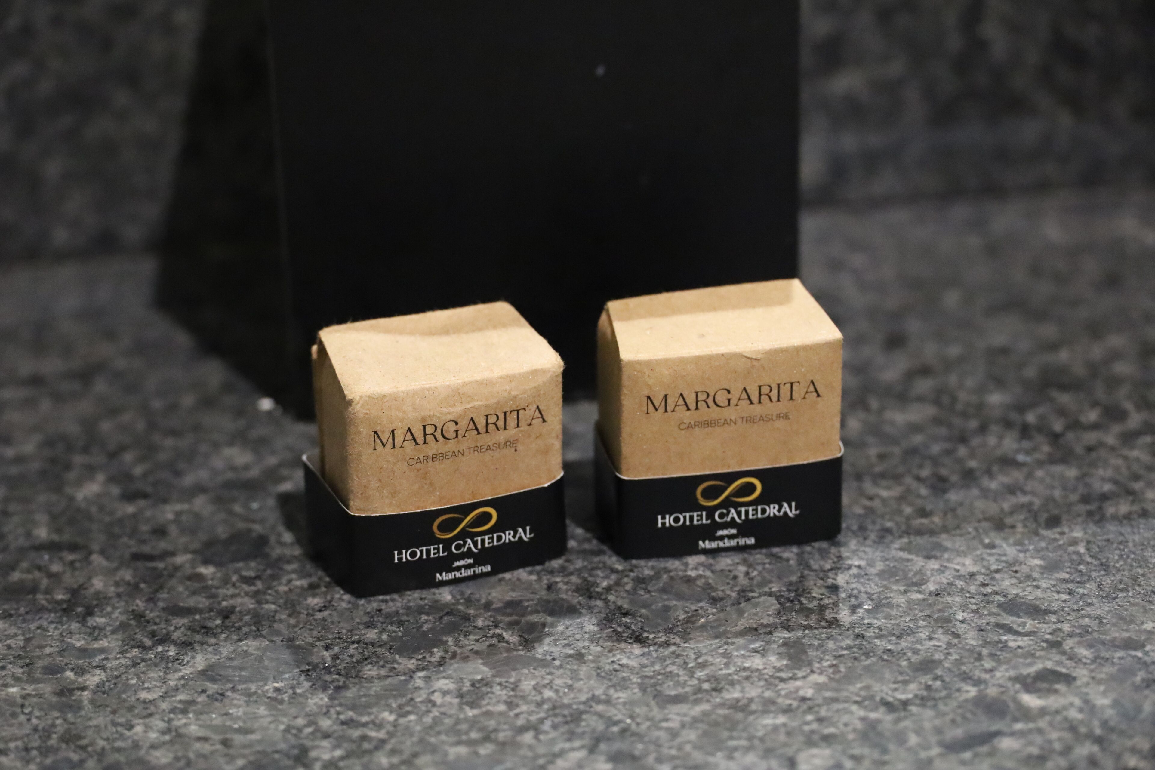 Two brown paper boxes labeled 'MARGARITA' and 'CARIBBEAN TREASURE' from 'HOTEL CATEDRAL' in 'MANDARINA'.