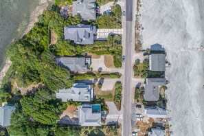 An aerial view of a residential area with houses, a road, and a beach. - Charleston Coast Vacations "The Blue Pelican" (Folly Beach)