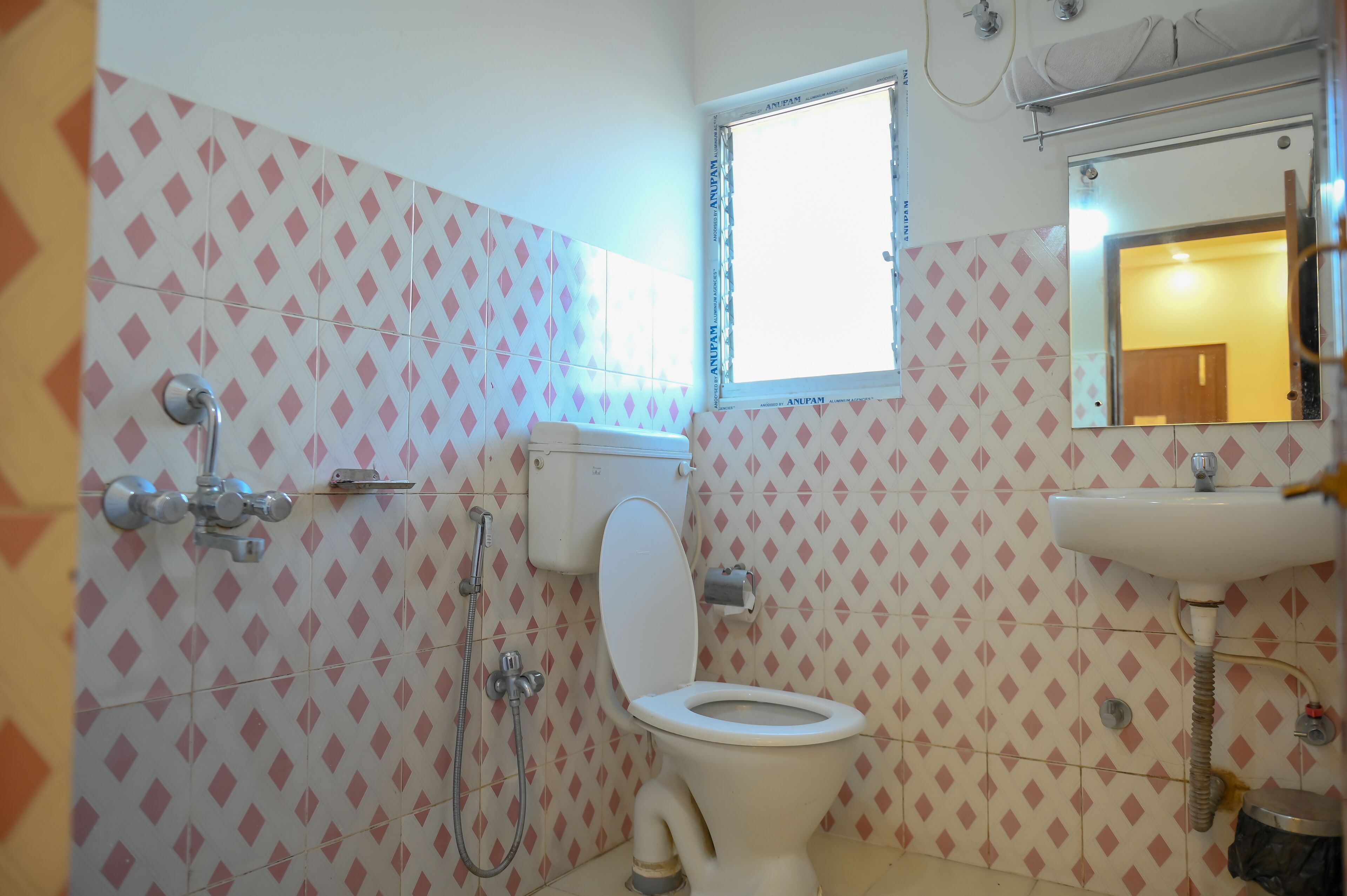 A bathroom with a toilet, a shower, and a sink.