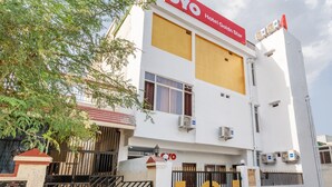 Un edificio blanco con un letrero rojo y blanco que dice "OYO Hotel Golden Star".