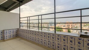A balcony with a tiled floor and a view of a residential area. - OYO 43619 Sahasra Residency (Hyderabad)