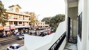 A busy street scene with buildings, vehicles, and pedestrians.