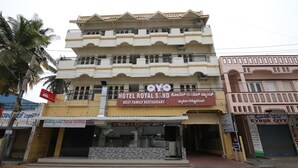 A multi-story building with a sign for Hotel Royal Sand and a family restaurant. - OYO 28093 Royal Sand (Mysore)