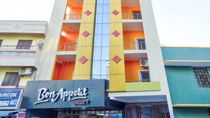 A multi-story building with a prominent bakery named "Bon Appetit" on the ground floor. - OYO 29878 Sri Abirami Inn (Puducherry)