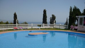A swimming pool with lounge chairs and a white fence. - pretty house with wonderful sea view wifi available throughout the property (Spagna)
