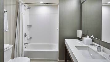 A modern bathroom with a bathtub, a toilet, and a sink.