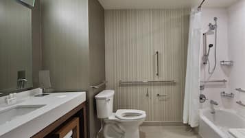 A modern bathroom with a sink, toilet, and shower.