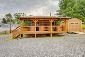 Situated on a quiet property, this cabin-style building offers a covered porch and attached garage.
