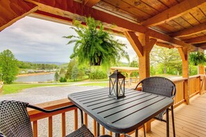 Enjoy a romantic meal on the deck overlooking the serene water and lush surroundings.