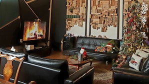 A cozy living room with a large chandelier, a fireplace, and a decorated Christmas tree. - BEAUTIFULL VINEYARD HOUSE (CASA MAZAHUA)  IN VALLE DE GUADALUPE (VALLE DE GUADALUPE)