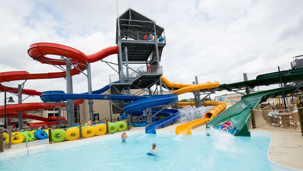 A water park with multiple slides and a pool area. - Great River Hotel (Burlington)
