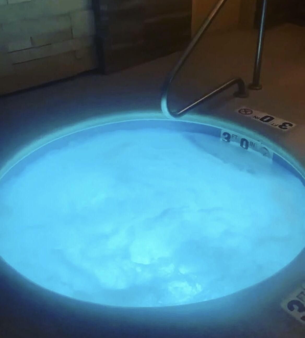 A hot tub with a visible depth marker indicating 3 feet.