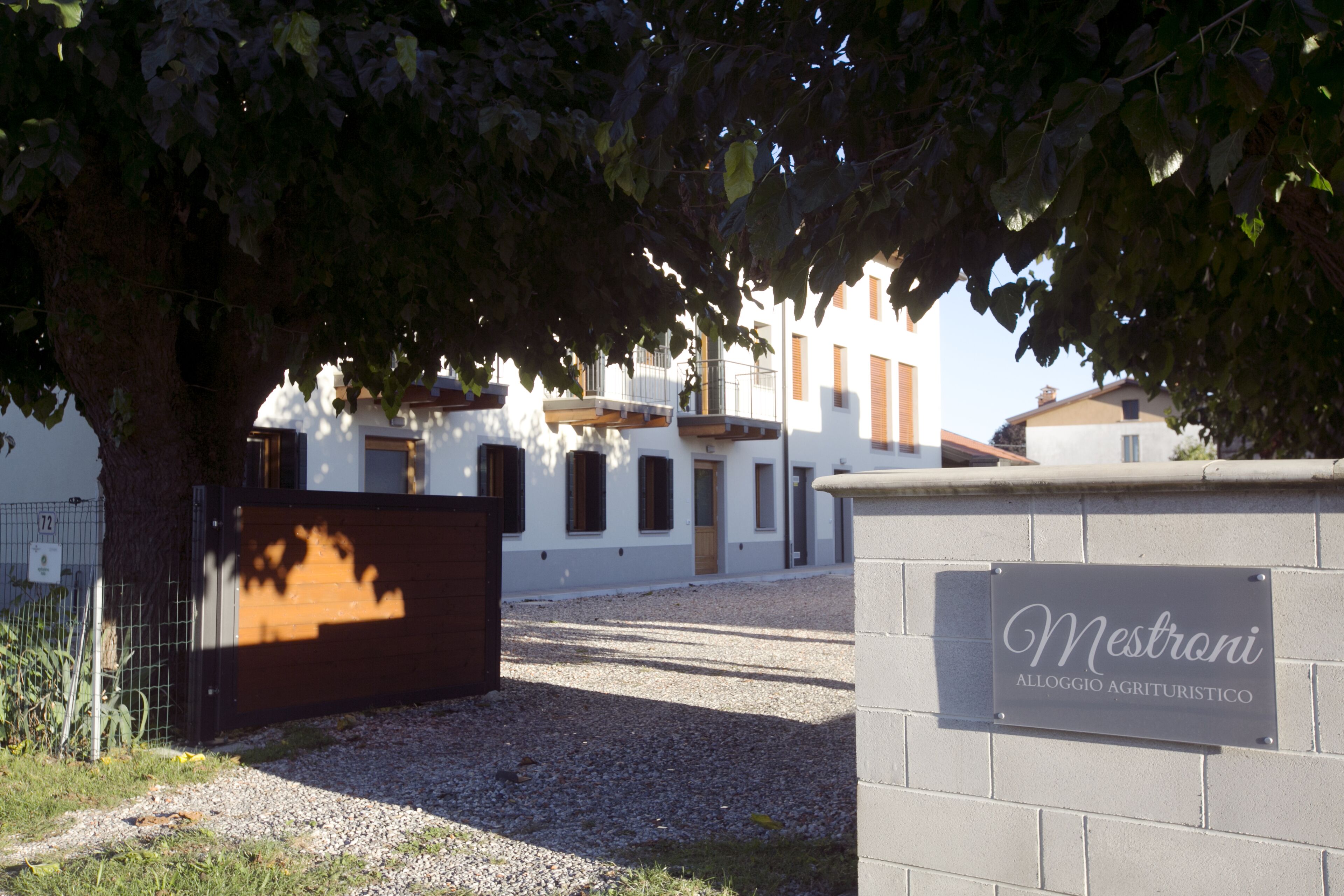 A gated entrance with a sign reading "Mestroni Alloggio Agrituristico."