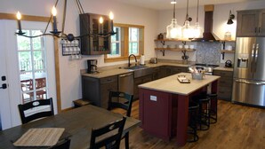 A modern kitchen with a central island, stainless steel appliances, and pendant lighting. - Cabin #7 Table Rock Lake WATER FRONT Oasis Retreat, Sleeps 10! (Kimberling City)