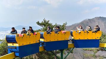 A roller coaster with passengers seated in the cars.