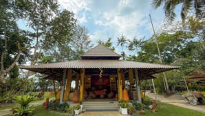 A traditional pavilion with a tiled roof, surrounded by lush greenery and palm trees. - Ko Kut Ao Phrao Beach Resort (Ko Kood)