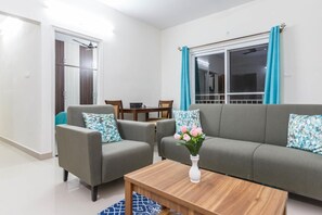 Relax in this stylish living room with a sofa, coffee table, and rug.